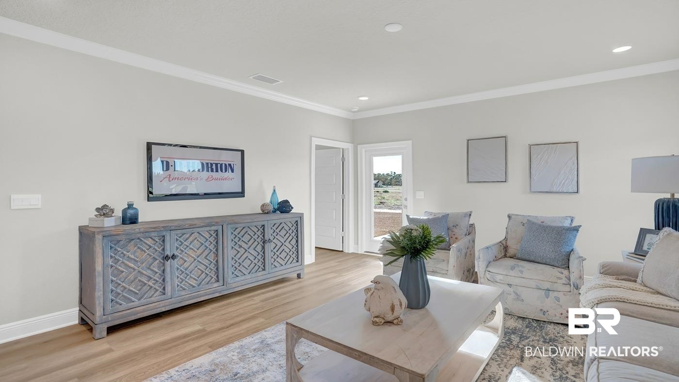 13312 Shea Circle Foley, AL 36535 - Photo 10 of 17 Spacious living area featuring light wood-finish flooring, a neutral wall palette, crown molding, and recessed lighting