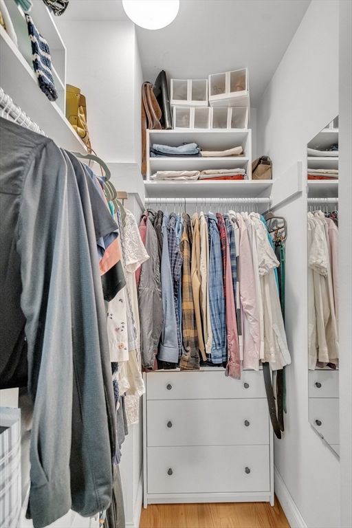 32 Juniper Street, Unit 91 Brookline, MA 02445 - Photo 11 of 21 a view of walk in closet with clothes and shoes