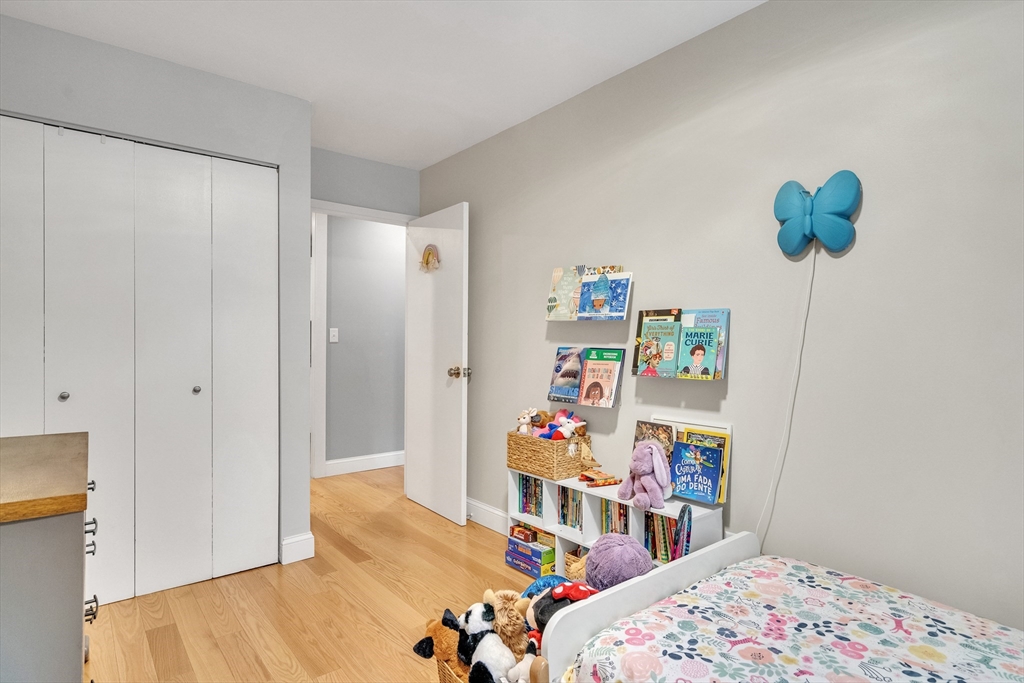 32 Juniper Street, Unit 91 Brookline, MA 02445 - Photo 13 of 21 a bedroom with a bed and a dresser in it