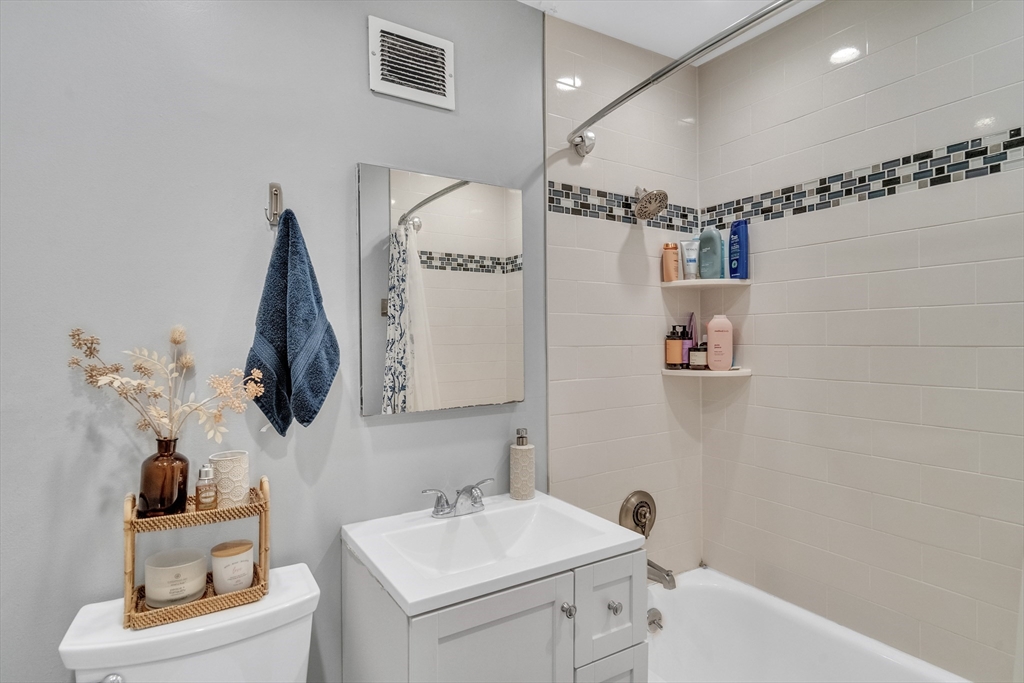 32 Juniper Street, Unit 91 Brookline, MA 02445 - Photo 14 of 21 a bathroom with a sink toilet and mirror