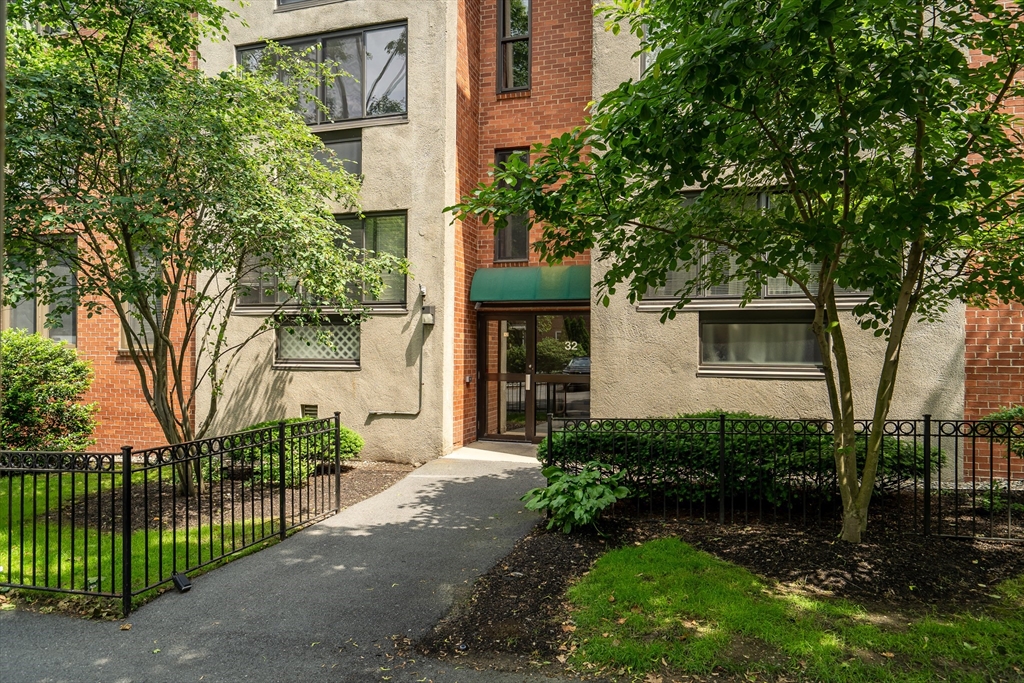 32 Juniper Street, Unit 91 Brookline, MA 02445 - Photo 20 of 21 a front view of a house with a garden