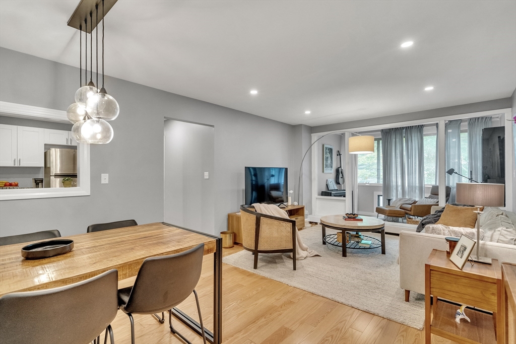 32 Juniper Street, Unit 91 Brookline, MA 02445 - Photo 2 of 21 a living room with furniture and a flat screen tv