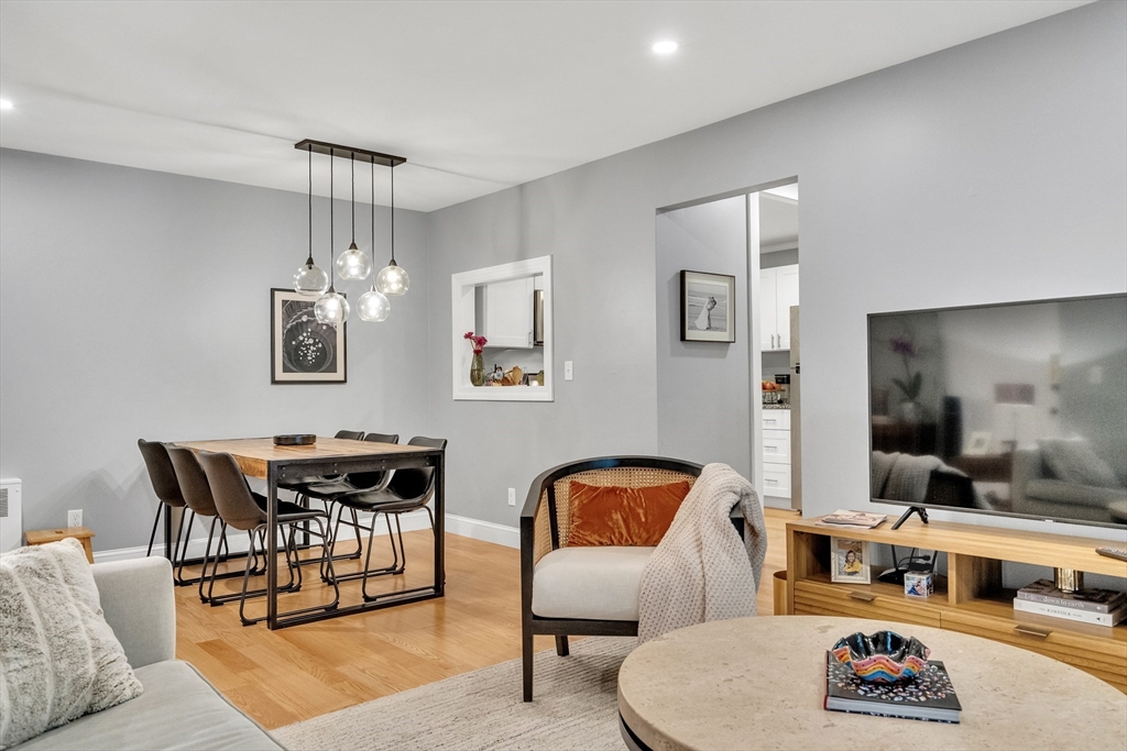32 Juniper Street, Unit 91 Brookline, MA 02445 - Photo 4 of 21 a living room with furniture and a dining table