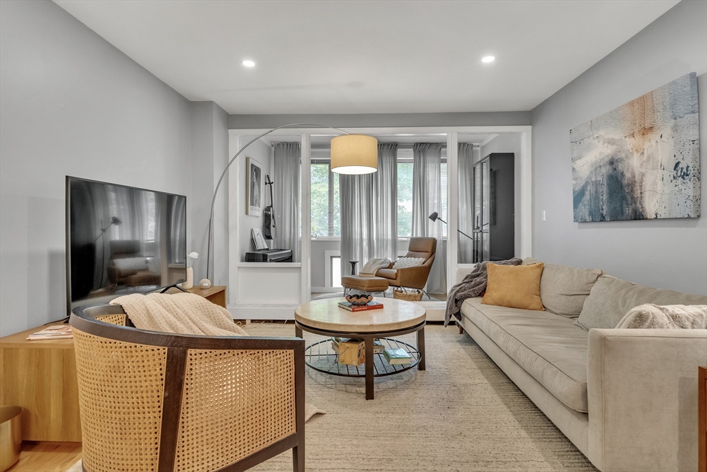 32 Juniper Street, Unit 91 Brookline, MA 02445 - Photo 5 of 21 a living room with furniture and a large mirror