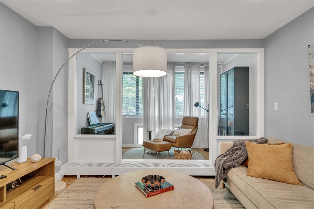 32 Juniper Street, Unit 91 Brookline, MA 02445 - Photo 6 of 21 a living room with furniture and a flat screen tv