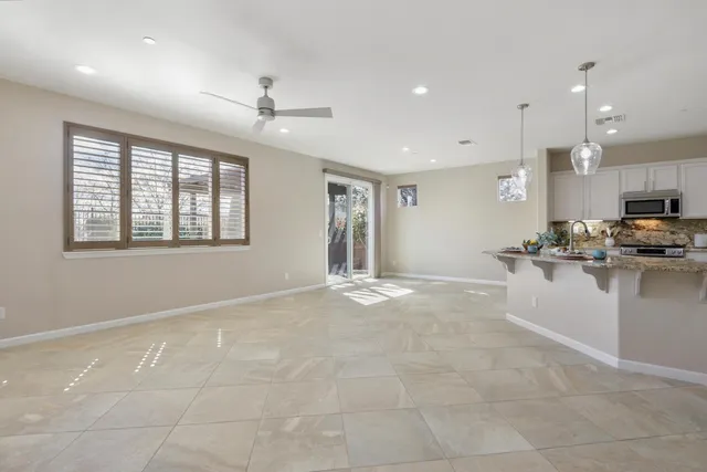 a kitchen with stainless steel appliances white cabinets white stove a refrigerator and microwave