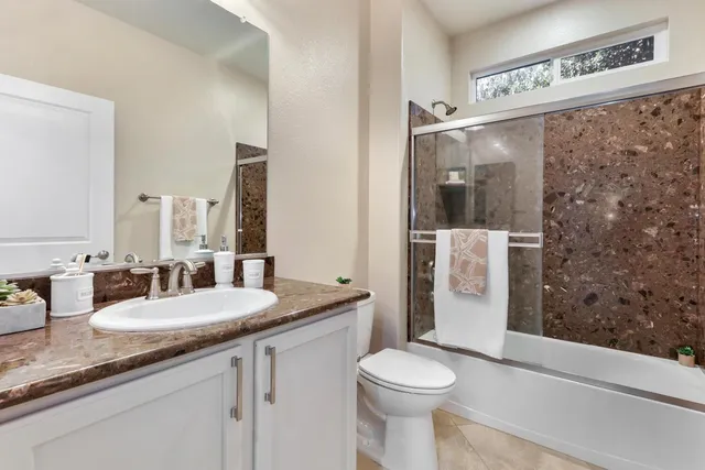 a street sign on a wall next to a road