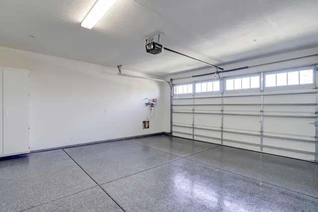 a living room with furniture large window and fire pit
