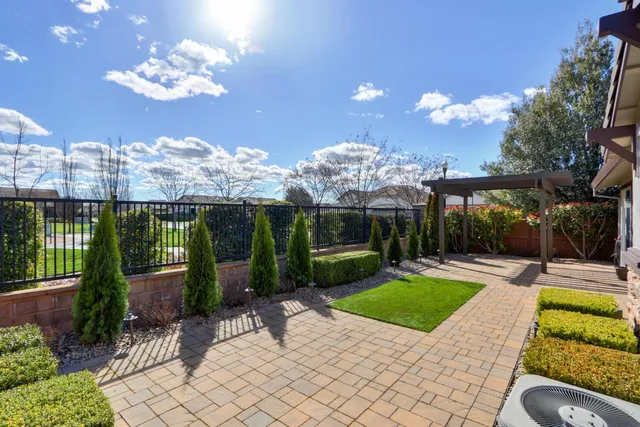 a view of a hallway with windows and a chandelier