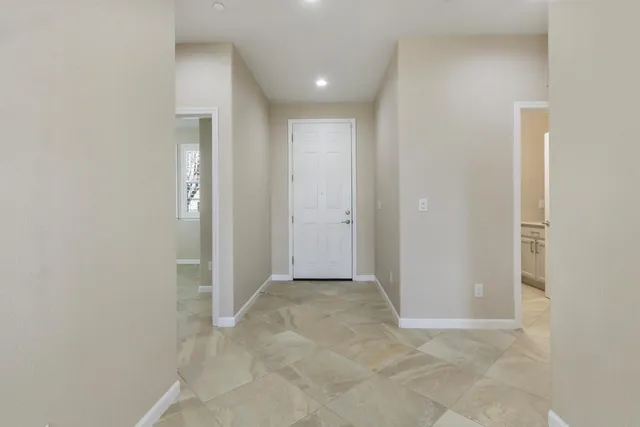 a view of a kitchen with refrigerator and a sink