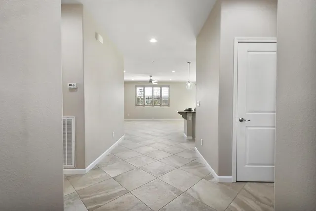 a large kitchen with a large counter top stainless steel appliances and cabinets