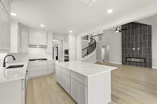 a kitchen with white cabinets and white appliances