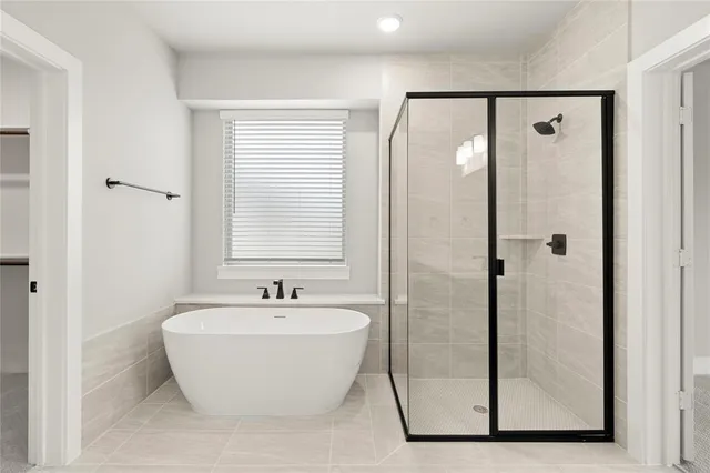 a bathroom with a bathtub and a shower