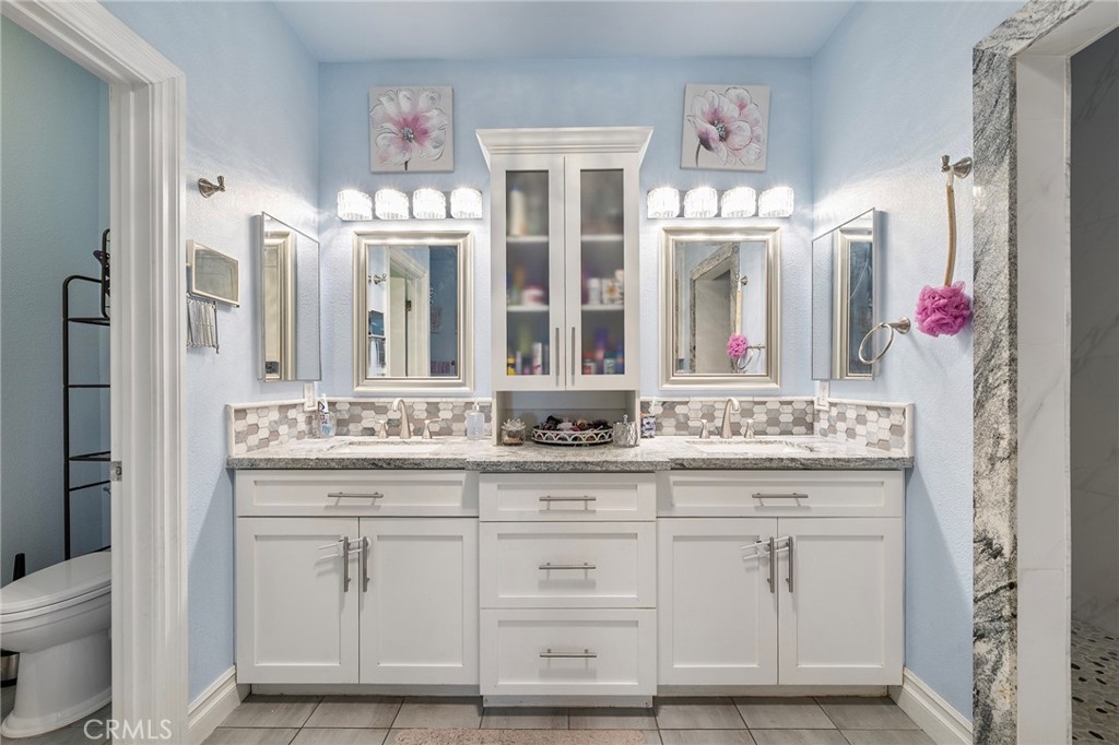 7172 Jargon Road Hesperia, CA 92344 - Photo 39 of 75 a bathroom with a sink vanity mirror and toilet