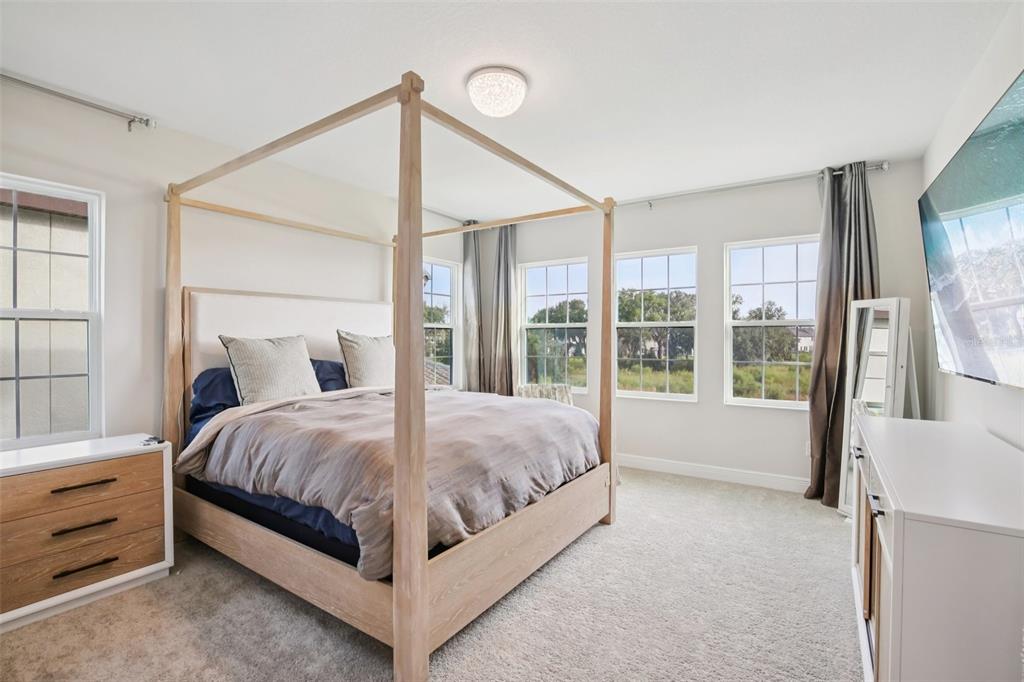 14930 Rider Pass Drive Lithia, FL 33547 - Photo 48 of 66 a bed sitting in a spacious bedroom next to a window