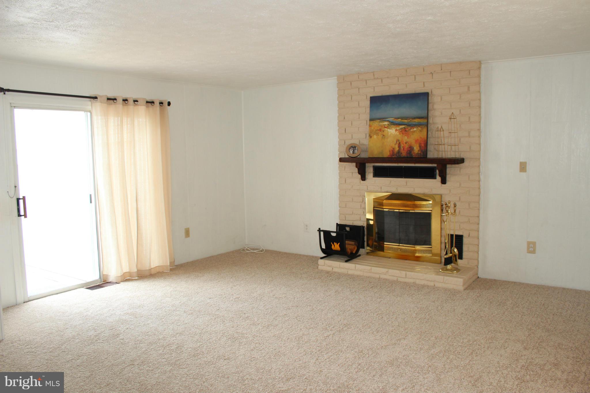 4214 Garrett Park Road Silver Spring, MD 20906 - Photo 13 of 22 an empty room with fireplace and mirror
