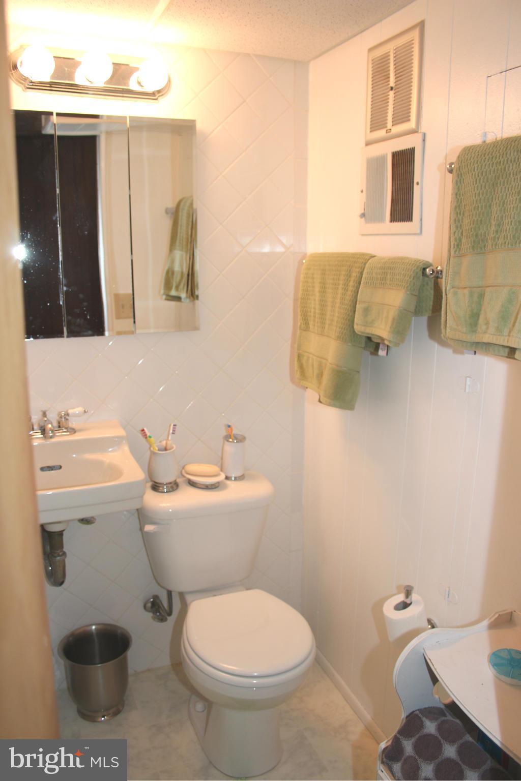 4214 Garrett Park Road Silver Spring, MD 20906 - Photo 18 of 22 a bathroom with a toilet sink and mirror