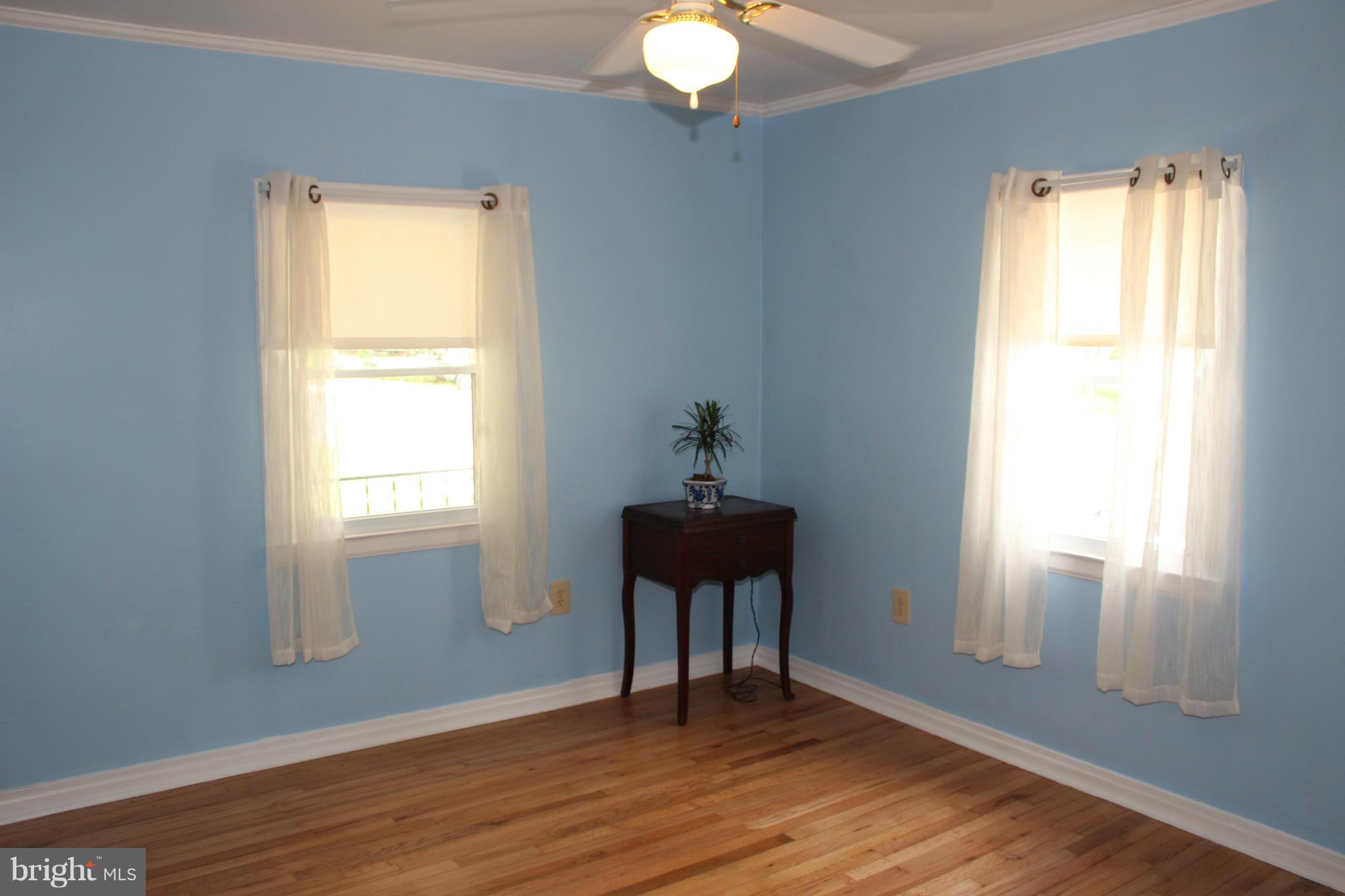 4214 Garrett Park Road Silver Spring, MD 20906 - Photo 7 of 22 a view of an empty room with wooden floor and a window