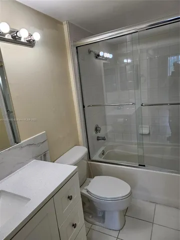 a bathroom with a toilet and shower