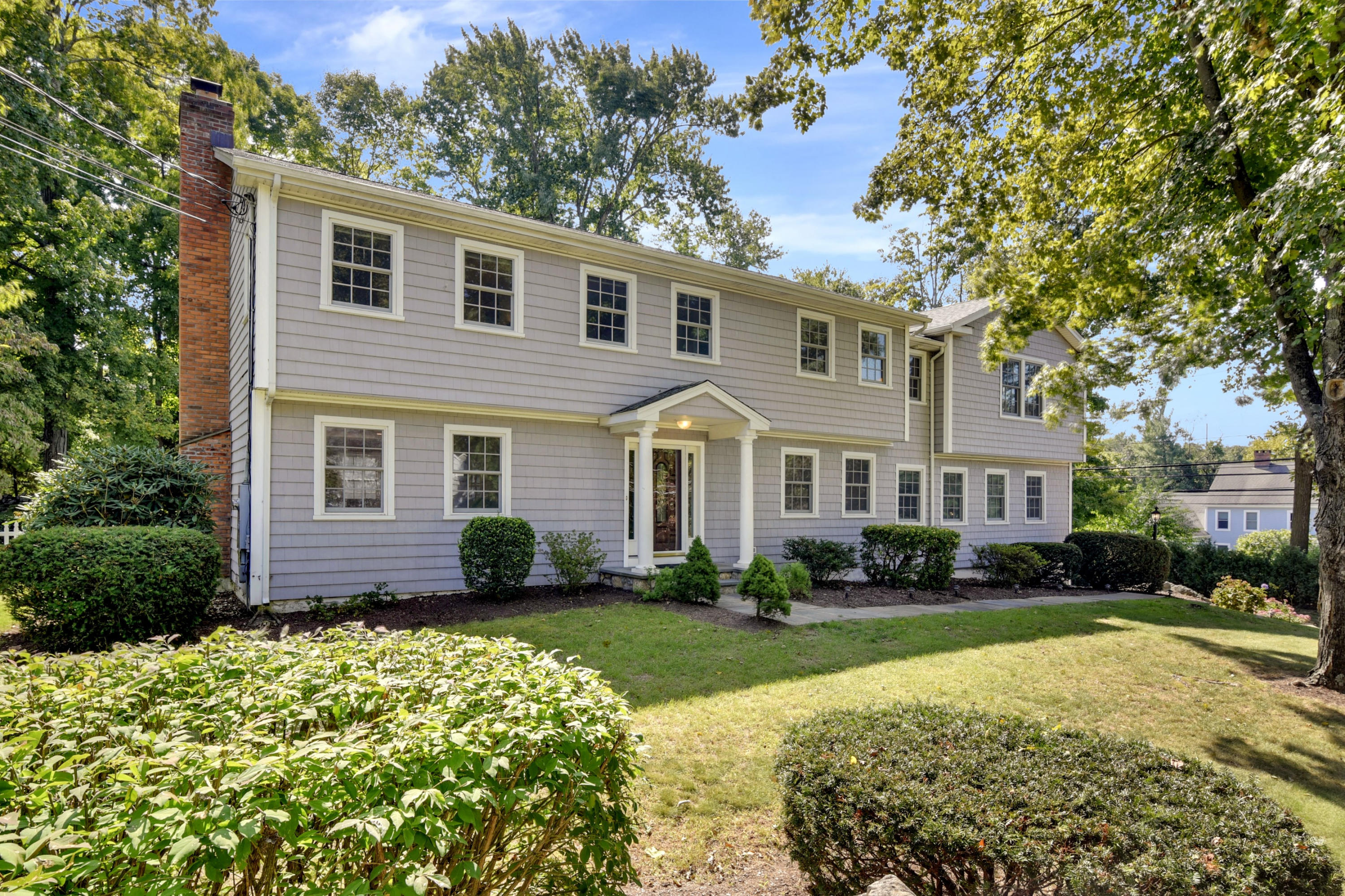 1 Country Club Road Darien, CT 06820 - Photo 1 of 25 a front view of a house with a yard