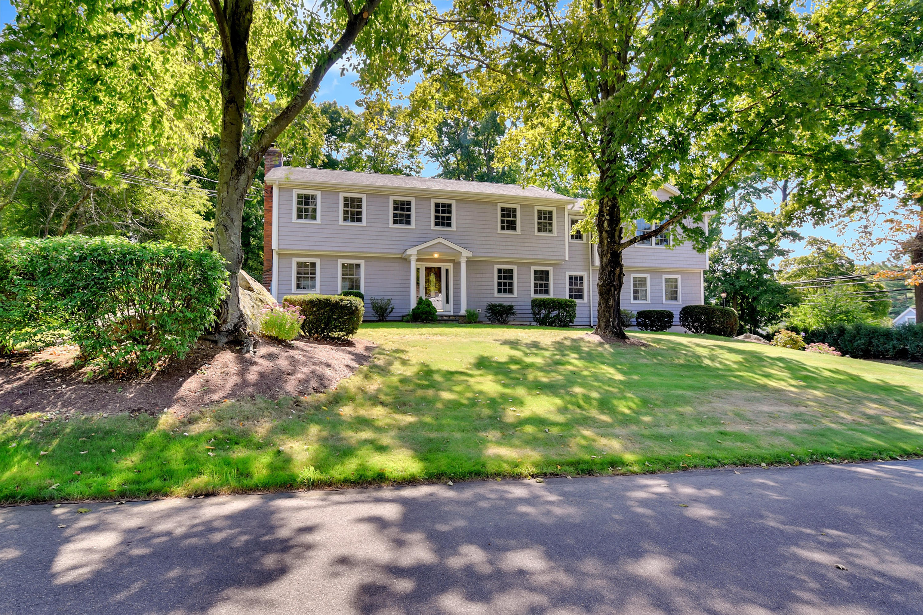 1 Country Club Road Darien, CT 06820 - Photo 2 of 25 a front view of a house with a garden and yard