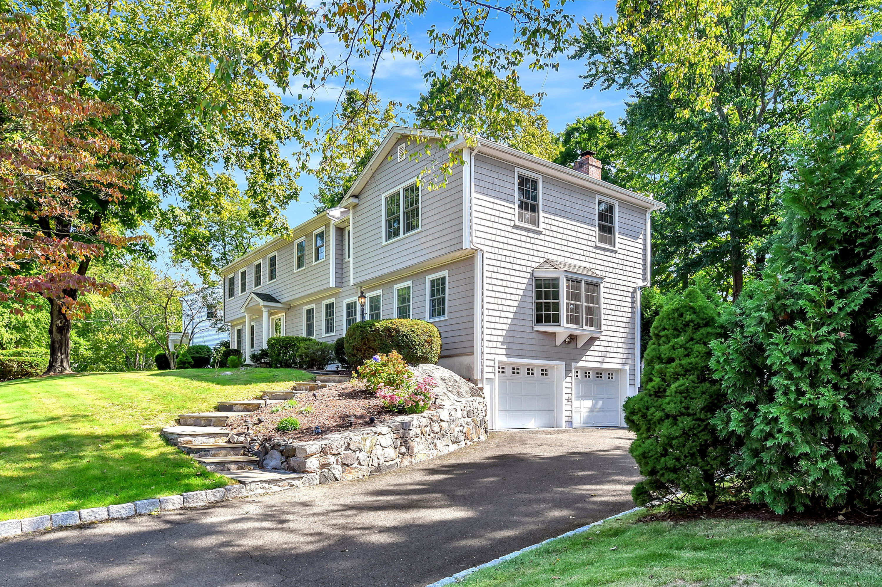 1 Country Club Road Darien, CT 06820 - Photo 3 of 25 a front view of a house with a garden