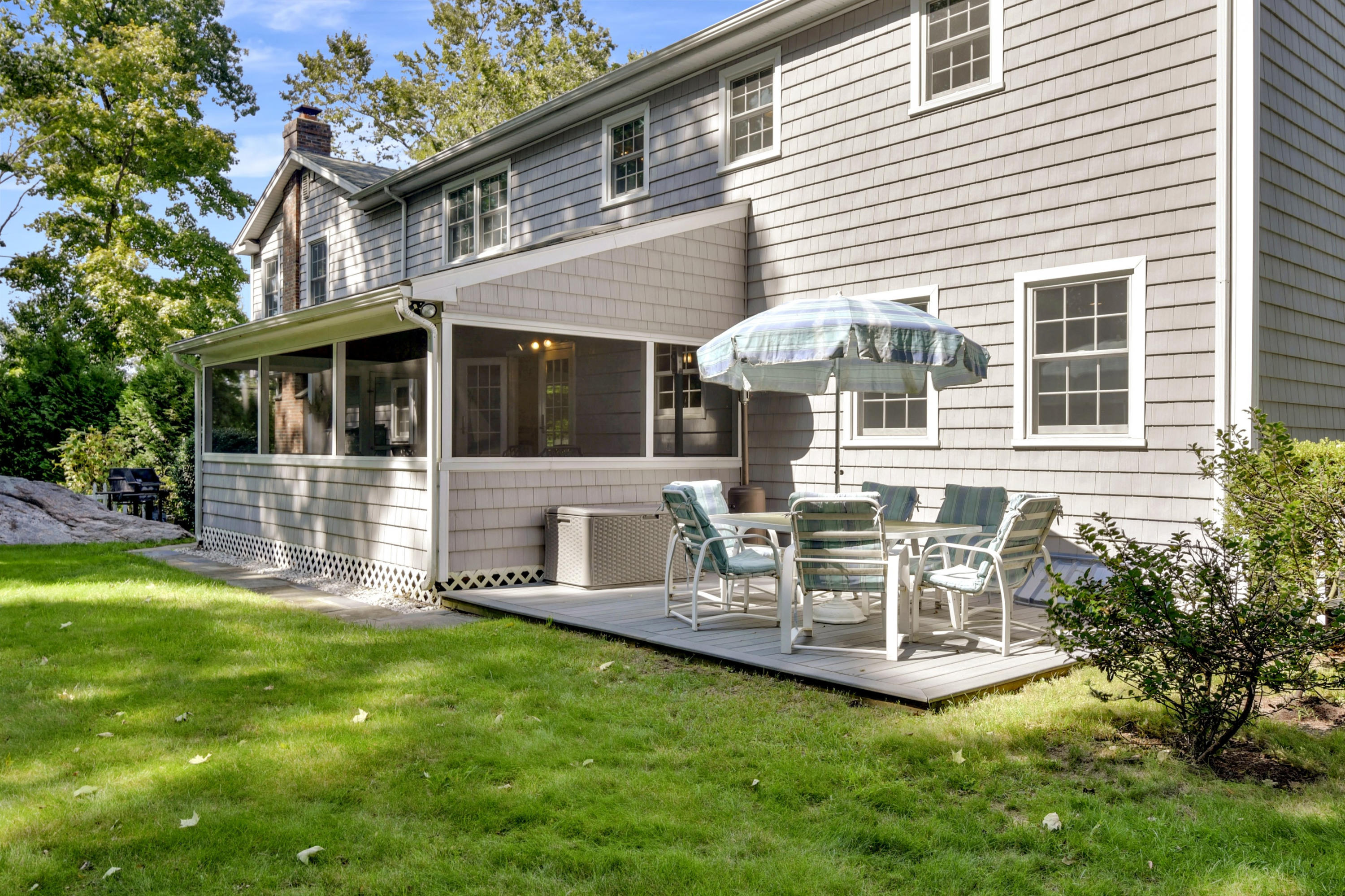 1 Country Club Road Darien, CT 06820 - Photo 22 of 25 a front view of a house with a yard glass top table and chairs