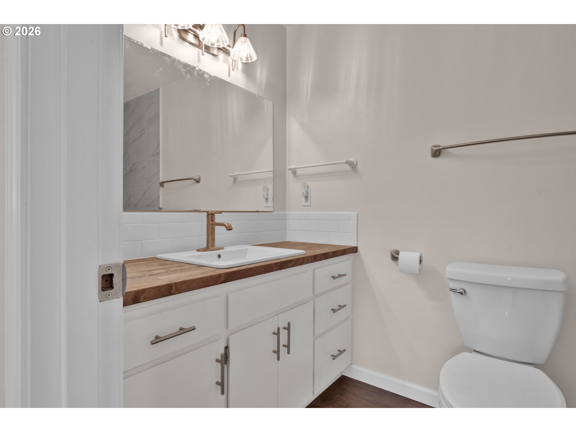 1142 9th Street Florence, OR 97439 - Photo 25 of 41 a bathroom with a toilet sink and mirror