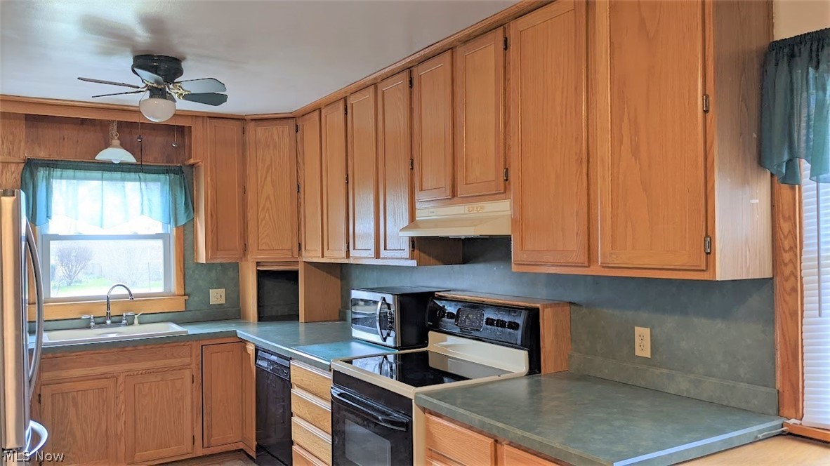 2841 Farmdale Road Akron, OH 44312 - Photo 4 of 22 Great kitchen with lots of cabinets, deep countertops on stove side, newer stainless refrigerator