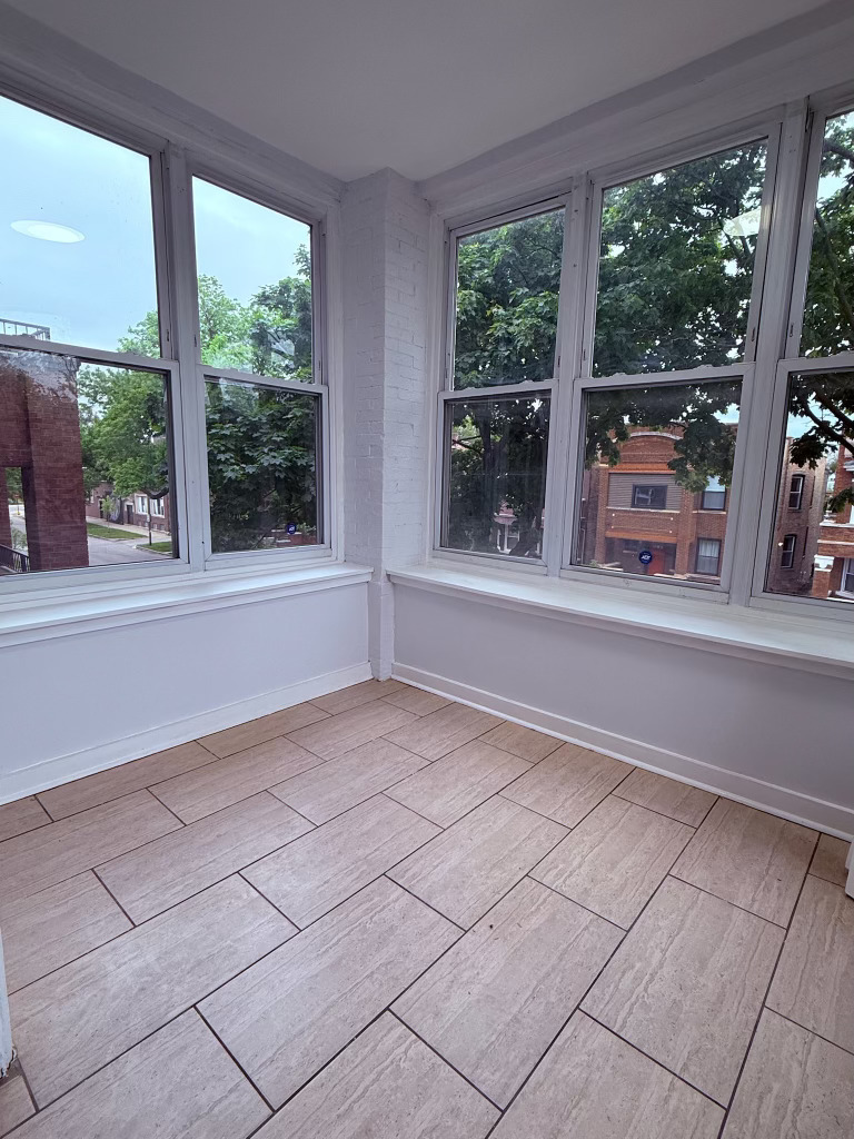 6928 South Green Street, Unit 2N Chicago, IL 60621 - Photo 4 of 11 a view of empty room with floor to ceiling windows and yard