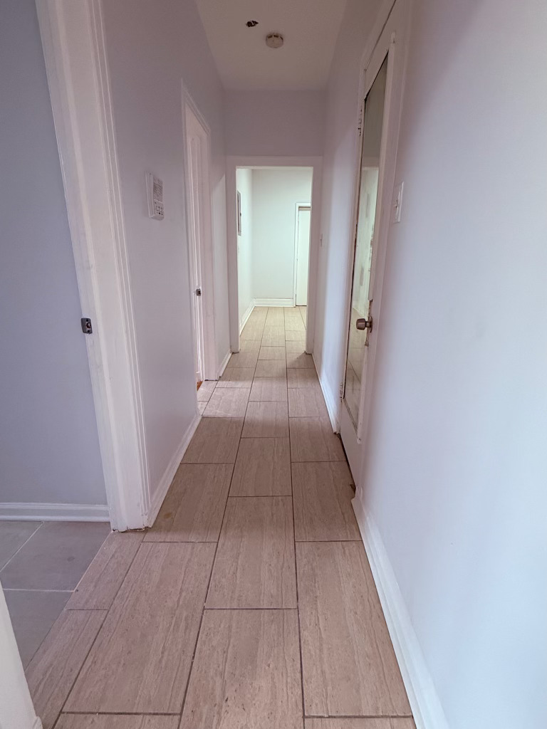 6928 South Green Street, Unit 2N Chicago, IL 60621 - Photo 6 of 11 a view of a hallway with wooden floor and a bathroom