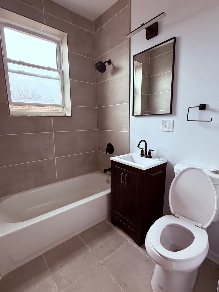 6928 South Green Street, Unit 2N Chicago, IL 60621 - Photo 8 of 11 a bathroom with a sink a toilet and a bathtub