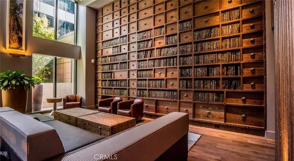 a living room with fireplace furniture and a large window