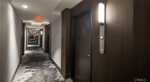 a view of a hallway view with wooden floor and living room