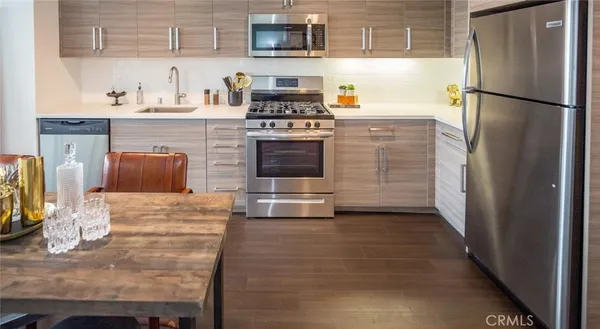 a kitchen with granite countertop a refrigerator and a stove