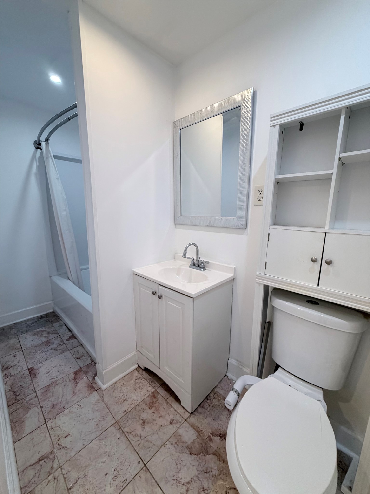 618 Sulphur Street Houston, TX 77034 - Photo 13 of 25 a white toilet sitting next to a bathroom sink