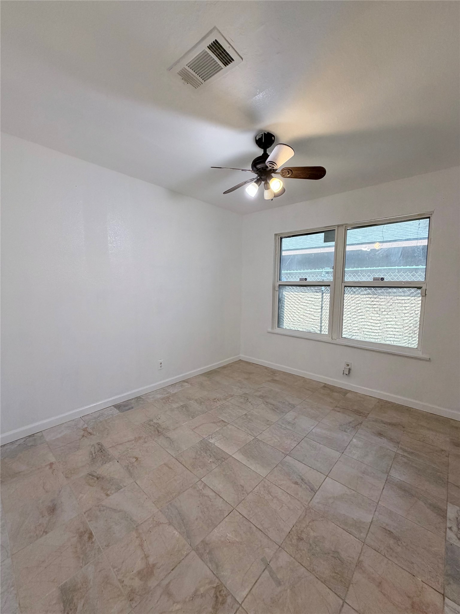 618 Sulphur Street Houston, TX 77034 - Photo 14 of 25 an empty room with chandelier fan and windows