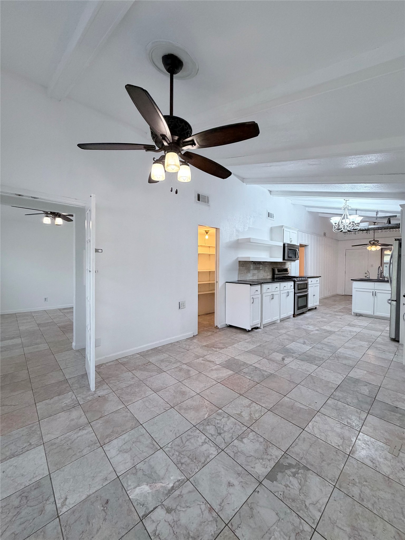 618 Sulphur Street Houston, TX 77034 - Photo 3 of 25 a view of a kitchen with a stove cabinets and a ceiling fan