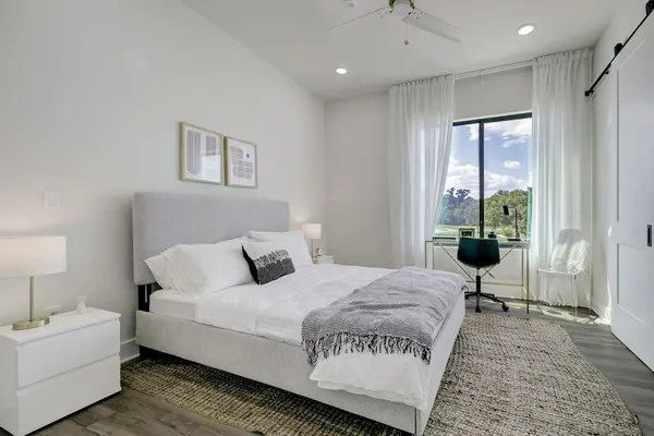 a spacious bedroom with a bed and a view of bathroom