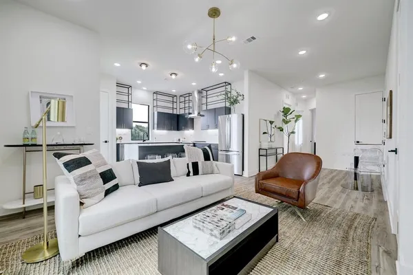 a kitchen with kitchen island a counter appliances a sink and cabinets