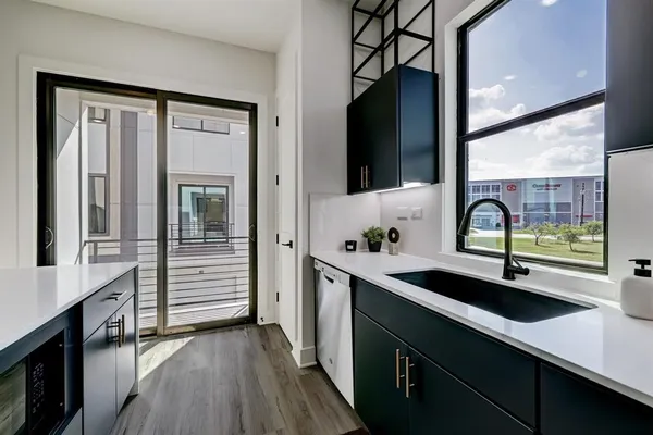 a bedroom with a bed a chair and a potted plant