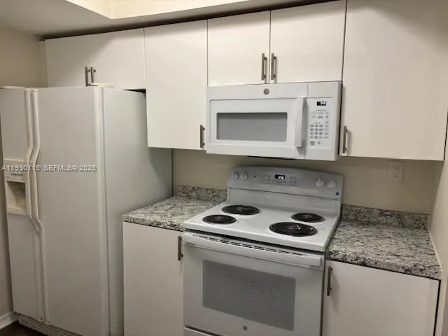 a kitchen with appliances cabinets and a counter top