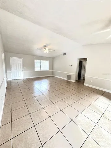 a view of a livingroom with wooden floor and a window