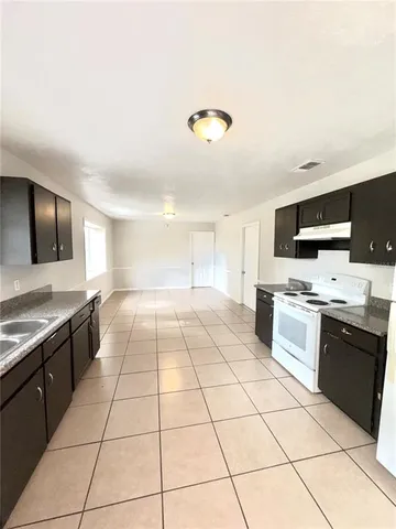 a large kitchen with stainless steel appliances lots of counter top space