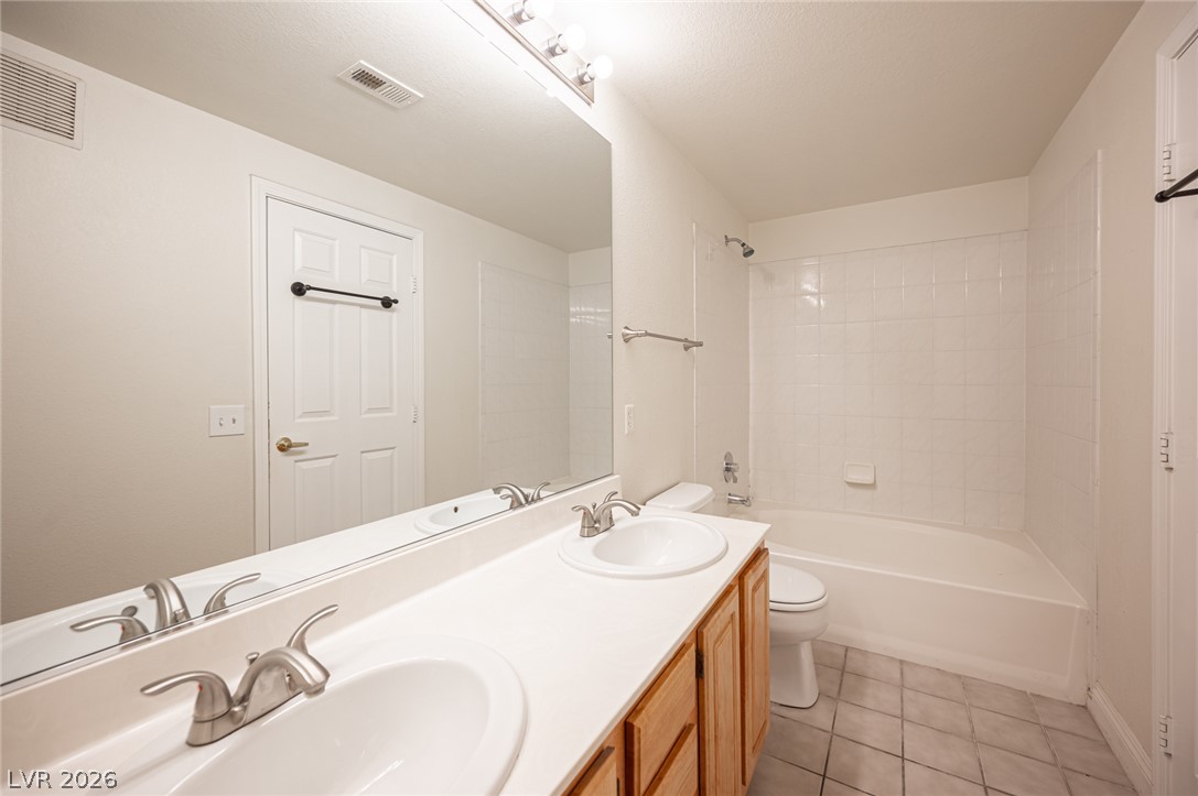 8555 West Russell Road, Unit 2062 Las Vegas, NV 89113 - Photo 23 of 35 A well-appointed bath features a double vanity and a shower-tub combination.