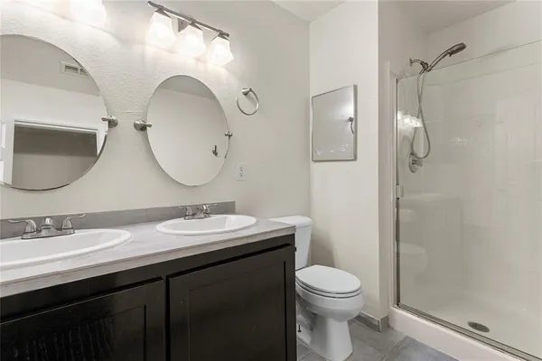 a bathroom with a toilet a sink and mirror