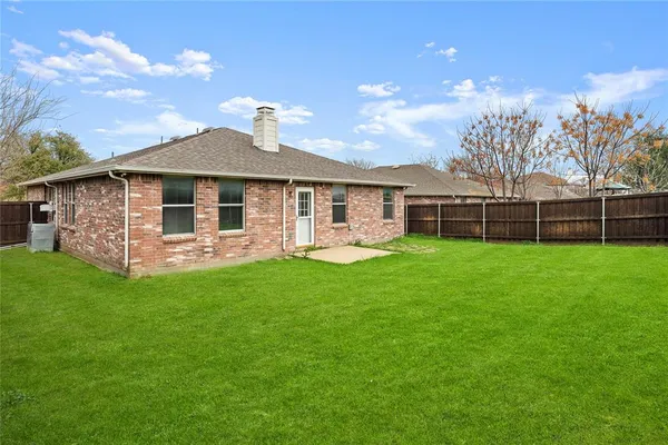 a front view of a house with a garden and yard