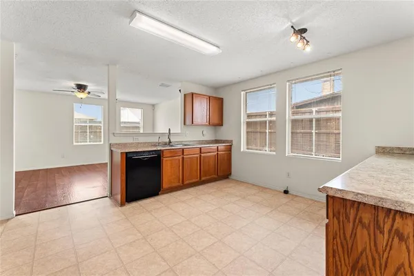 a kitchen with stainless steel appliances granite countertop a stove a sink dishwasher and a refrigerator