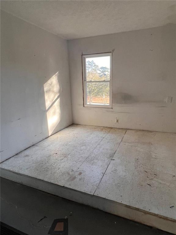 1401 Stone Bridge Lane Conyers, GA 30094 - Photo 19 of 27 an empty room with windows