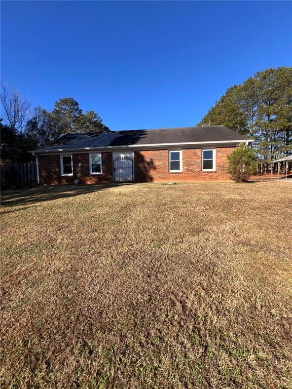 1401 Stone Bridge Lane Conyers, GA 30094 - Photo 2 of 27 a front view of a house with a yard